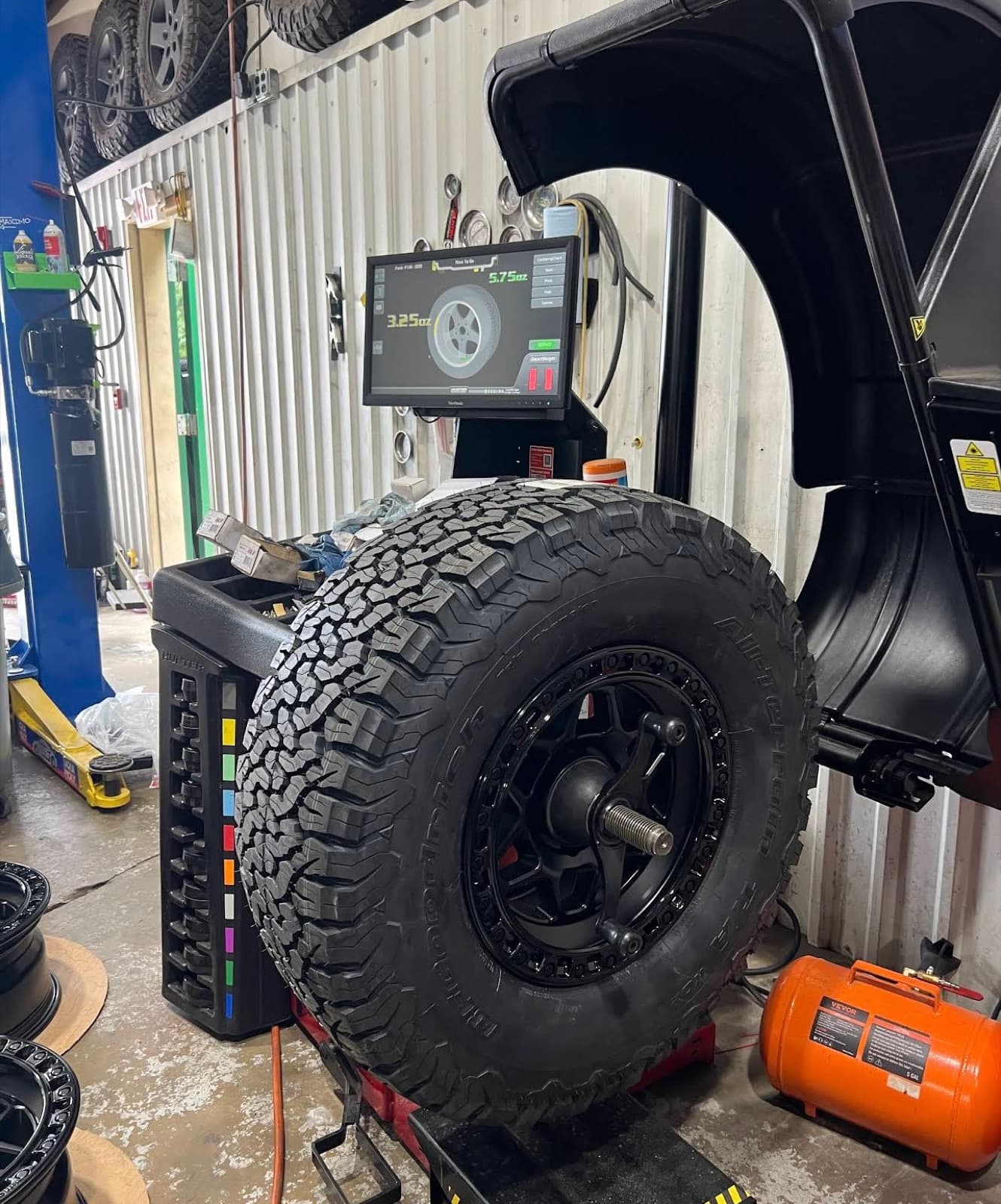 BFGoodrich all-terrain tire on a beadlock wheel being road-force balanced on a Hunter machine
